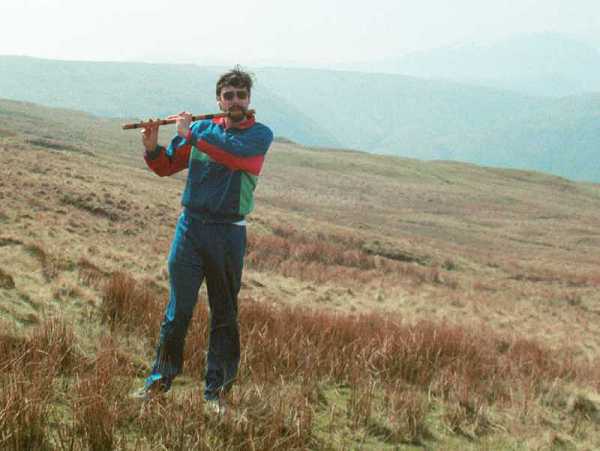 Photo of me playing flute on a Welsh moor